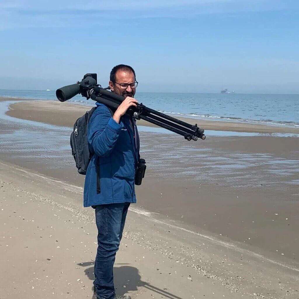 Birder at shore in Italy